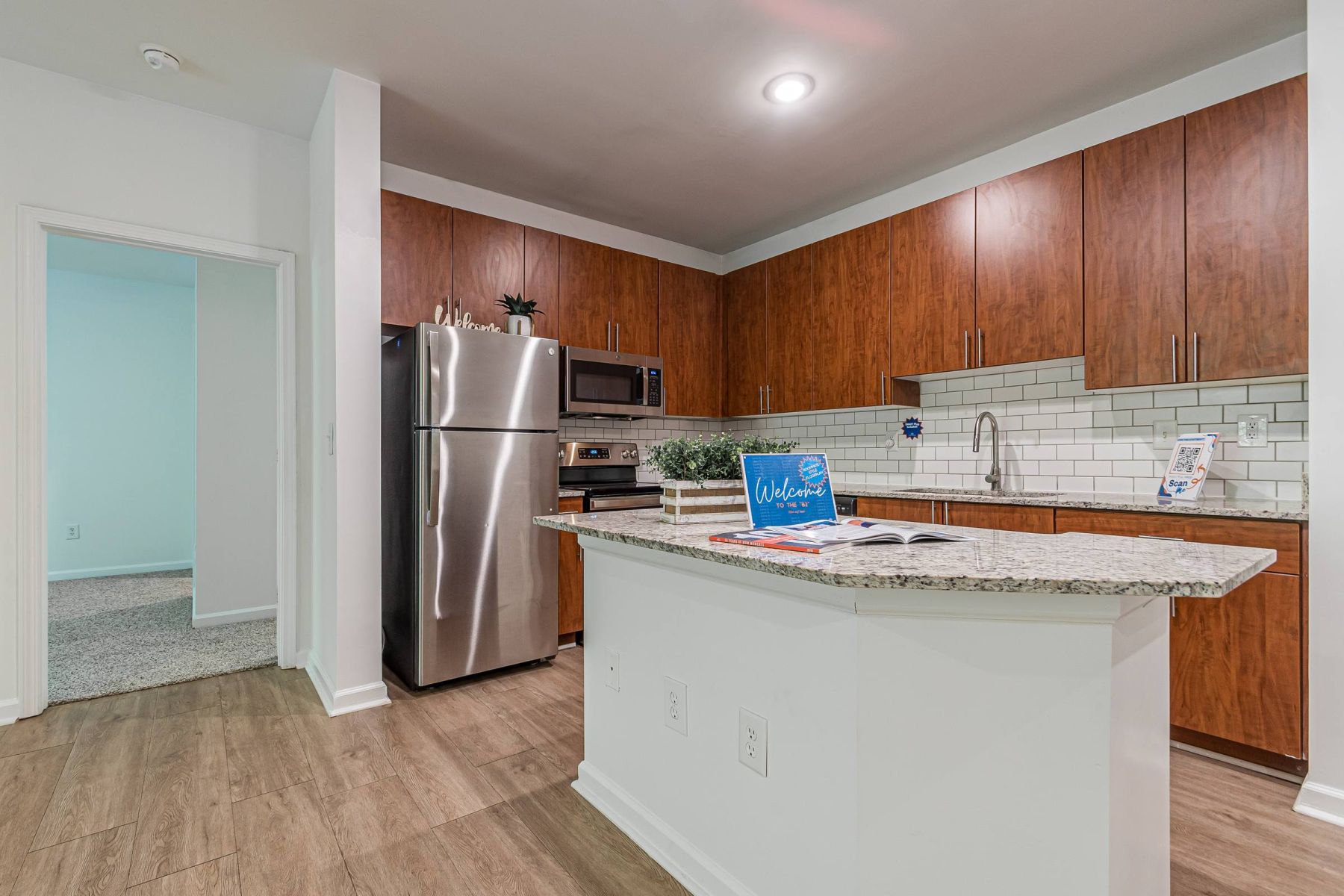 Luxury apartment kitchen with stainless steel appliances, granite countertops, and lots of storage space